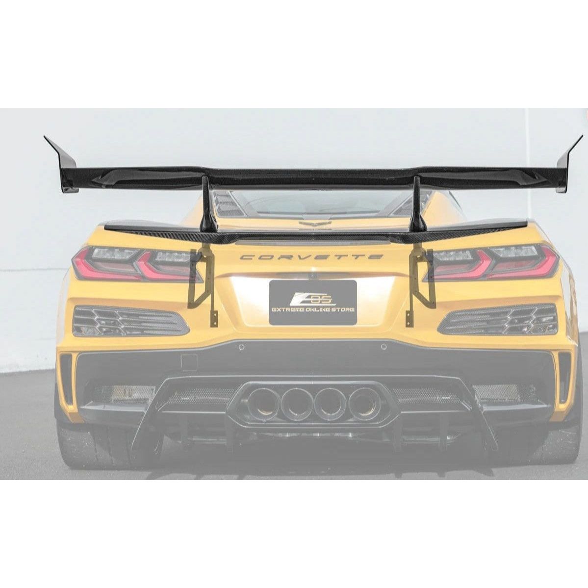 Yellow Corvette car with a black rear wing on a gray background