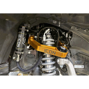 Close-up of vehicle suspension system with ICON branded components.