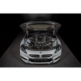 Eventuri gloss carbon CSL strut brace installed on BMW G8X M3 S58 engine bay
