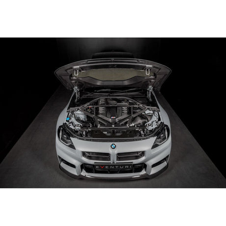Eventuri gloss carbon CSL strut brace installed on BMW G8X M3 S58 engine bay
