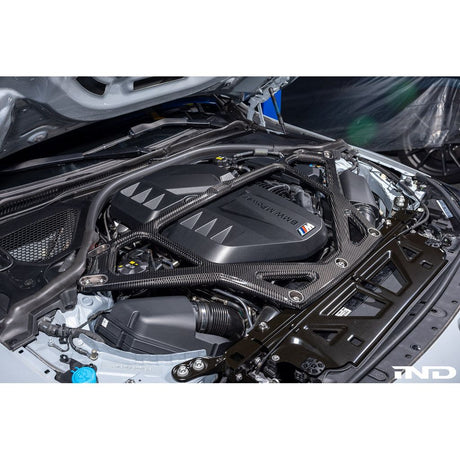 Eventuri gloss carbon CSL strut brace installed on BMW G8X M3 S58 engine bay