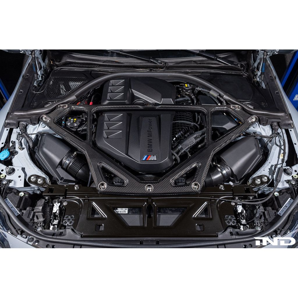 Eventuri gloss carbon CSL strut brace installed on BMW G8X M3 S58 engine bay
