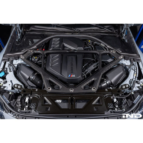 Eventuri gloss carbon CSL strut brace installed on BMW G8X M3 S58 engine bay